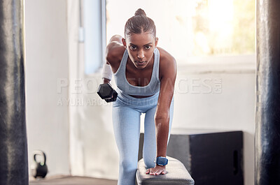 Buy stock photo Fitness, dumbbell weight and black woman doing a workout for strength, health and wellness in a gym. Motivation, athlete and healthy African girl doing an arm exercise or training in a sports center.
