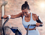 Fitness, woman and intense cycling at the gym for exercise, workout or healthy cardio training. Active female exercising on stationary bicycle or machine for health, wellness and endurance indoors