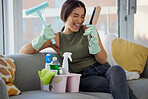 Cleaning, housework and woman sitting on sofa with smile, detergent and happy excitement for chores in living room. Home maintenance, girl in clean and fresh house, housekeeping and spring clean work