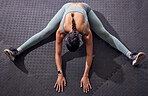 Top view, woman or stretching on floor in gym workout, training or exercise in muscle pain relief, tension release or body flexibility. Sports athlete, personal trainer or coach in warm up for health