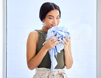 Buy stock photo Laundry, cleaning and smell with woman and clothes for fresh, fragrance and aroma from housekeeping. Fabric, cleaner and soft with girl enjoying scent of detergent, care and sanitary on material