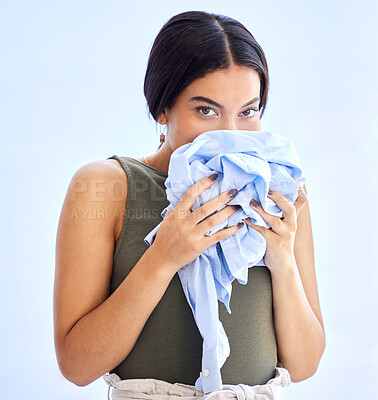 Buy stock photo Fresh, laundry and woman smelling clean clothes with a smile, peace and calm in mockup studio background. Scent, clean and female smell clothing aroma, linen and clothes in morning with happiness
