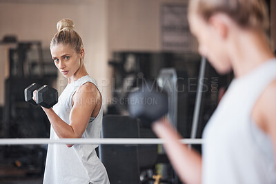 Buy stock photo Fitness, dumbbell and woman bodybuilder, weightlifting in gym, mirror with reflection and focus during workout. Cardio, muscle and strong with bicep and body weight training, wellness and health.