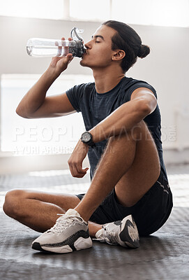 Buy stock photo Water bottle, fitness and gym man tired after a fitness training, exercise challenge and wellness goal with healthy diet or nutrition. Young sports person floor drinking water for healthy lifestyle