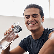 https://photos.peopleimages.com/picture/202211/2557835-fitness-water-bottle-and-portrait-of-a-man-on-a-break-after-an-intense-workout-or-training-in-the-gym.-sports-rest-and-happy-athlete-drinking-a-beverage-while-resting-after-exercise-in-sport-center-box_175_175.jpg