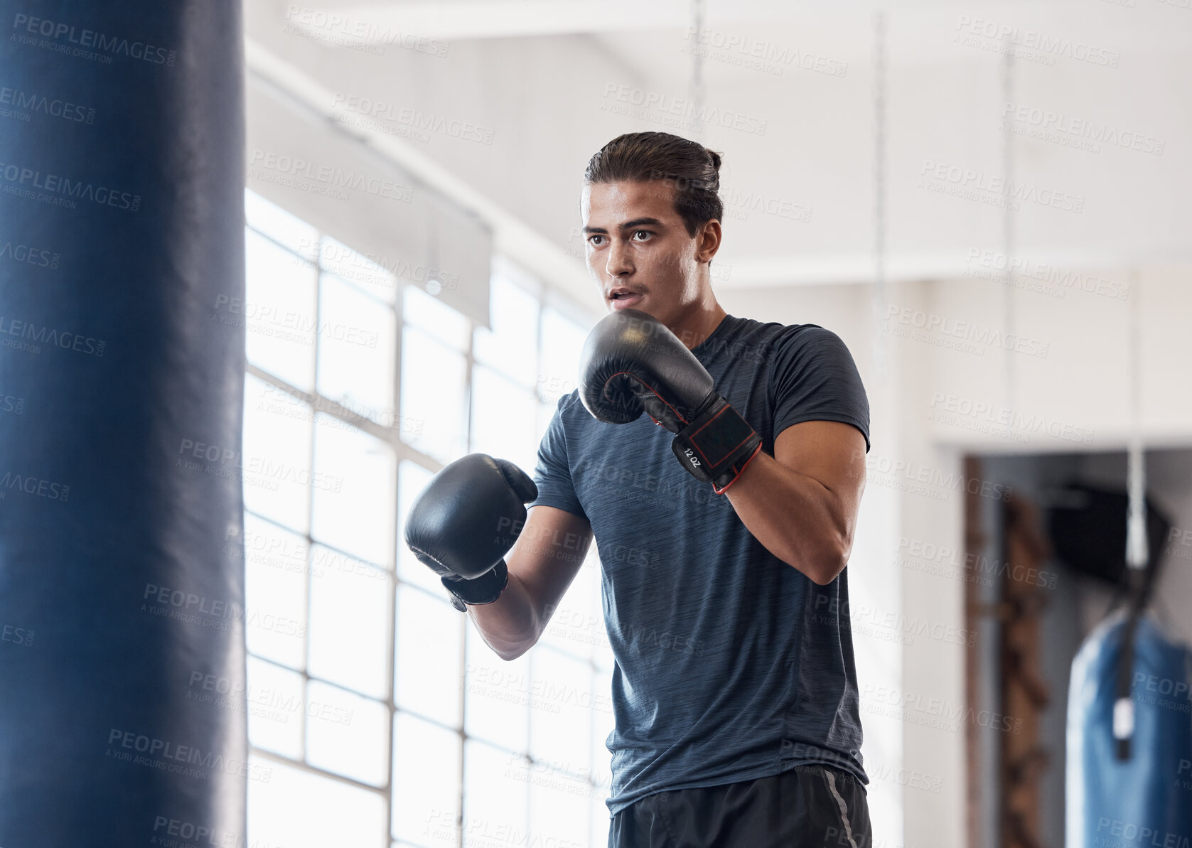 Buy stock photo Fitness, training and boxing with man in gym for workout, exercise and sports stamina. Cardio, energy and power with athlete and punching bag for martial arts, performance and action in dojo club
