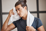 Fitness, man sweat and tired fo exercise, training and fatigue in gym for health and wellness with towel. Man, young and gen z in sport club, healthy or workout with cloth for dry, sweat or skin 
