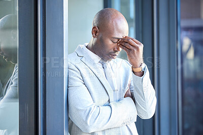 Buy stock photo Stress, headache and tired African businessman outside the office taking a break from work. Frustrated, burnout and overworked professional manager working overtime at his workplace in the urban city