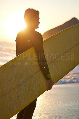 Beach, surfer and man with a surfboard at sunset thinking of of fitness training, workout or water sport exercise outdoors. Silhouette, freedom and healthy athlete on a holiday vacation for surfing