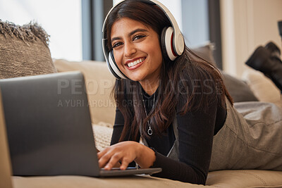 Buy stock photo Headphone, woman and relax on laptop, happy and listening to music, podcast or watch a movie on the sofa in home. Portrait, young girl and happy with streaming subscription app, audio or social media