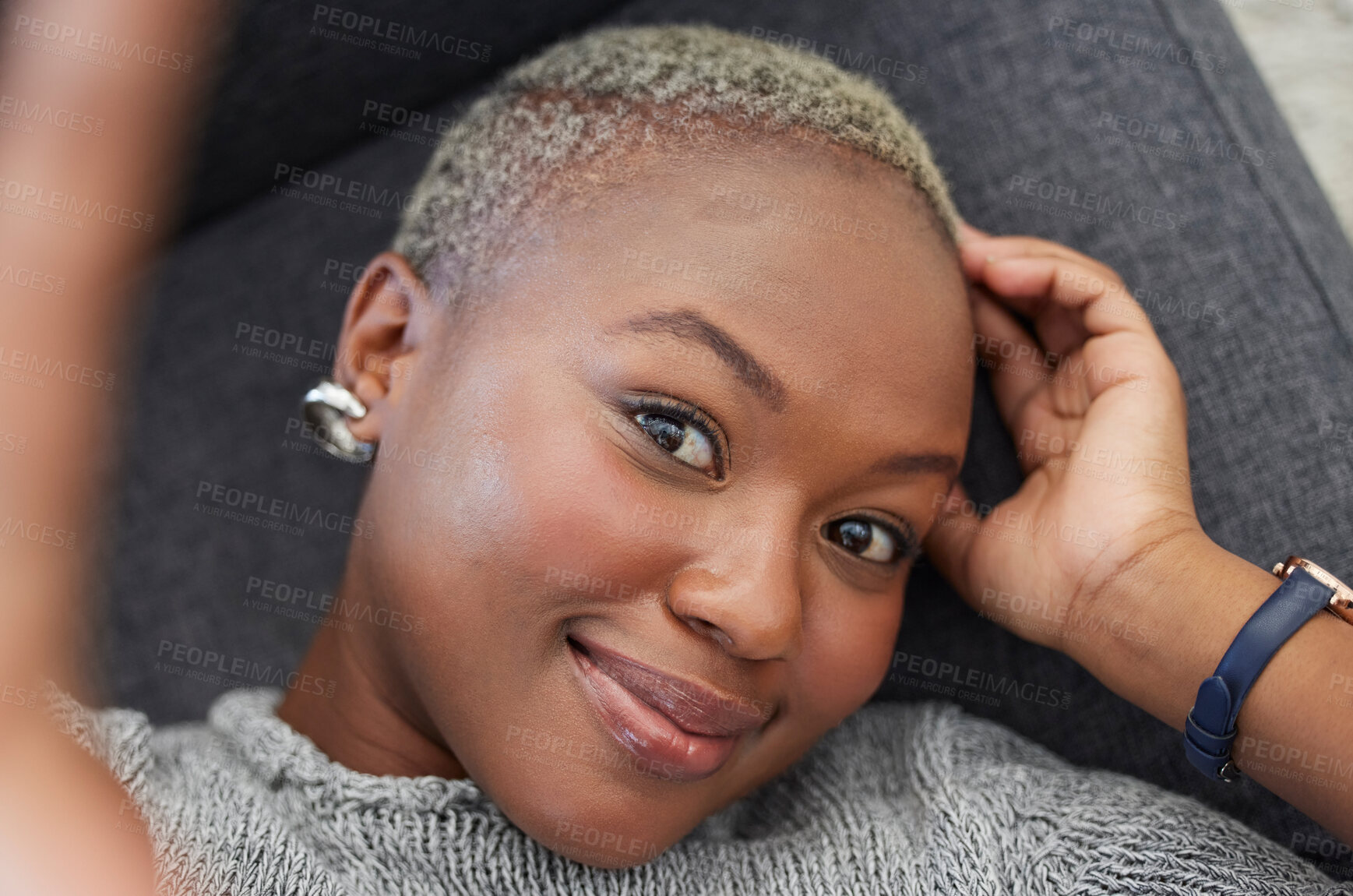 Buy stock photo Smile, black woman on sofa and phone selfie, taking a profile picture for social media or online dating app. Relax, happy and woman laying on living room couch taking photo for self love from above.