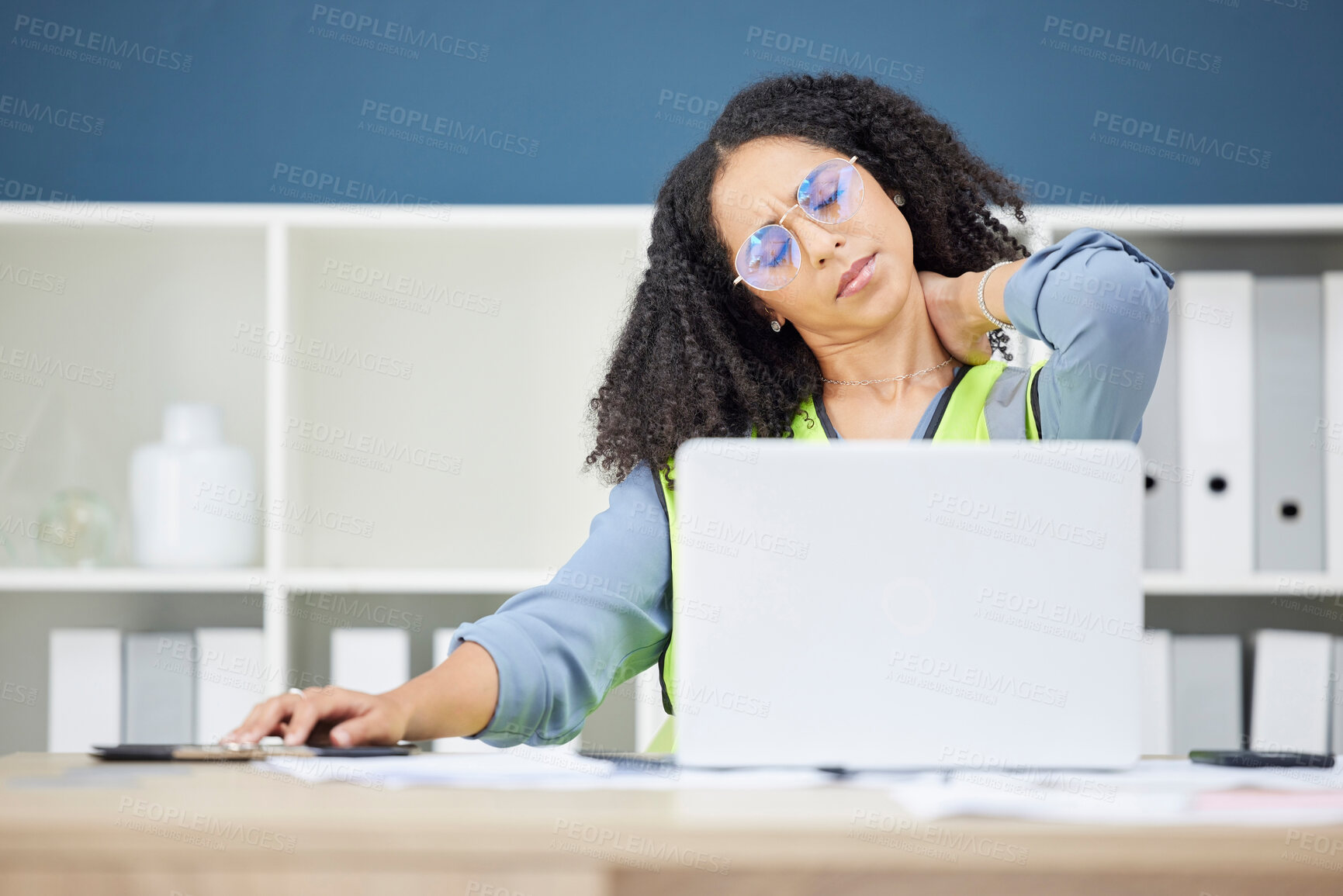 Buy stock photo Woman architect, laptop and neck pain in stress, burnout or overworked at the office. African American female employee suffering from neck ache, inflammation or spasm working on computer at workplace