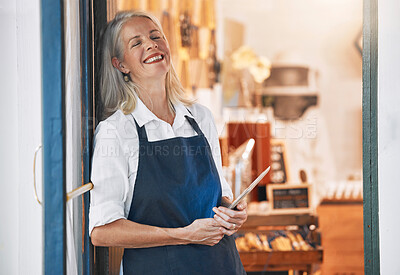 Buy stock photo Happy senior business owner with a tablet in her store for startup with technology or mobile device. Leader, entrepreneur and elderly woman standing by an open door to welcome customers in the shop.