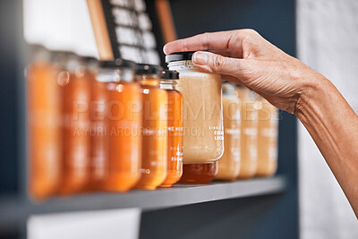 Buy stock photo Hands, jar and honey shelf for inventory check, product pricing or labeling in organic retail store. Hand in small business, management or market advertising of healthy glass food products for sale