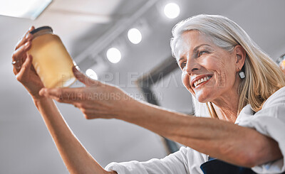 Buy stock photo Elderly small business woman, hands and honey with smile for successful organic product in the retail store. Happy senior entrepreneur holding sweet glass jar and smiling for business career success