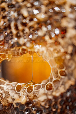 Buy stock photo Nature, honeycomb and texture drip macro for nutrition, health and bee farming production. Natural, textures and zoom of raw, organic and golden honey process for a healthy lifestyle.


