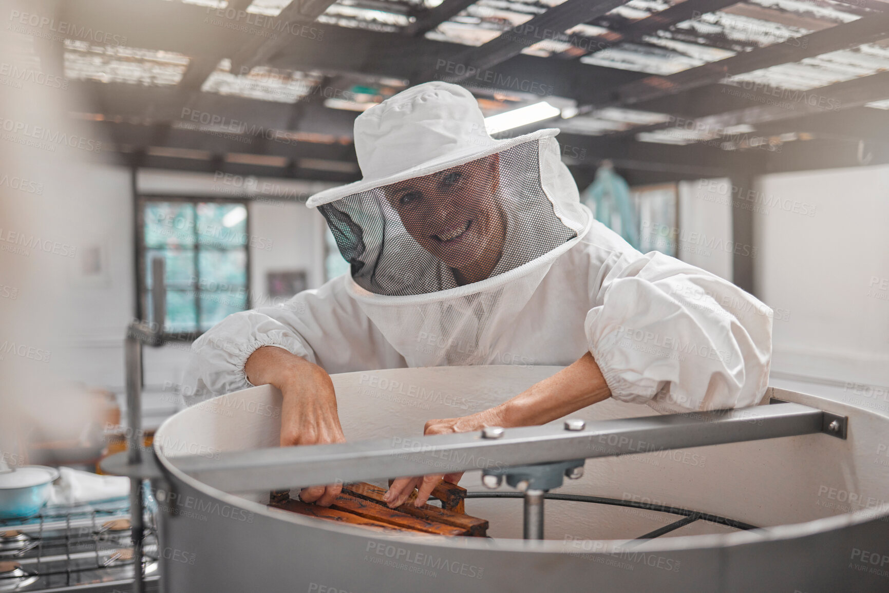 Buy stock photo Woman, beekeeper and workshop, bee farming for honey and natural product, farm and small business owner with hive maintenance. Organic, bees and safety suit, elderly person smile in portrait.