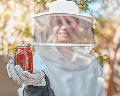 Buy stock photo Hand, honey and jar with a woman beekeeper working in the countryside in the production of a natural product. Farm, agriculture and sustainability with a female farmer holding a honeyjar outdoor