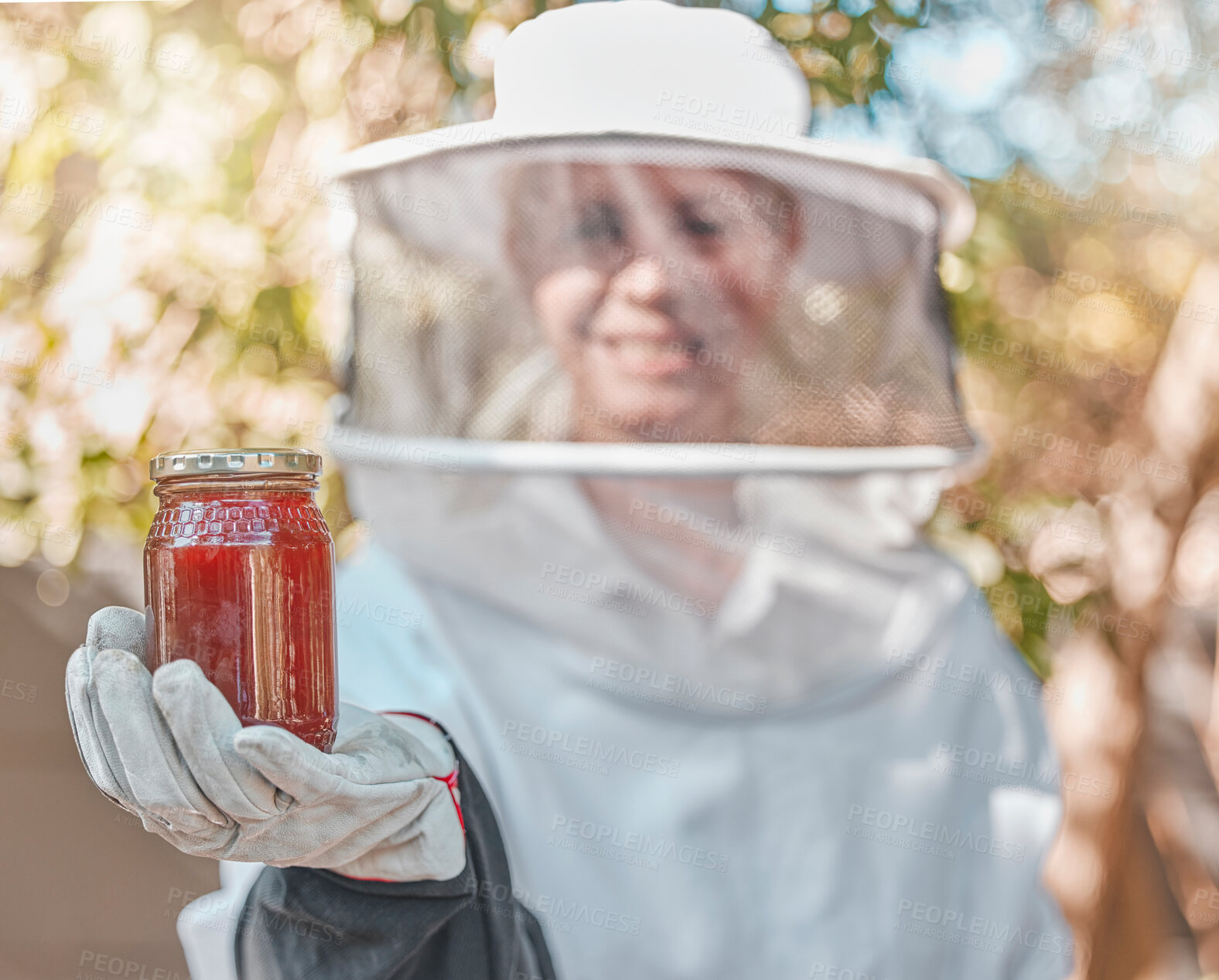 Buy stock photo Hand, honey and jar with a woman beekeeper working in the countryside in the production of a natural product. Farm, agriculture and sustainability with a female farmer holding a honeyjar outdoor