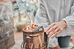 Agriculture, fire and hands of a beekeeper in production of honey with smoke in container. Sustainability, eco friendly and business owner with a smoking pot for start of honeycomb farming in nature