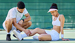 Tennis player, woman and injury legs with man, help and care on tennis court at training. Coach, mentor and training helping girl at match, sport or game with pain, muscle or emergency at workout