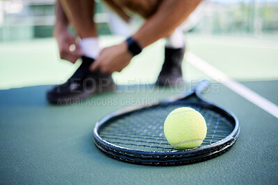 Buy stock photo Tennis ball, racket and man tie shoes on tennis court preparing for competition, game or match. Exercise, fitness and tennis player getting ready for practice, training or workout outdoors on field.