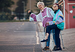 Hand, thumbs up and senior women with disability in a road for travel, fun and waiting for taxi in a city. Elderly, friends and disabled seniors hitchhiking while waiting for cab ride in a street