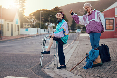 Buy stock photo Hitchhiking, disability and travel with senior friends standing on a corner looking for a trip with a hand sign or gesture. Transport, road and handicap with a mature woman and friend hitching a ride