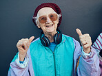 Senior woman, headphones and stylish fashion with glasses for modern lifestyle, comdey happiness and freedom in studio. Dance hands, streaming music and happy funky elderly person with smile 