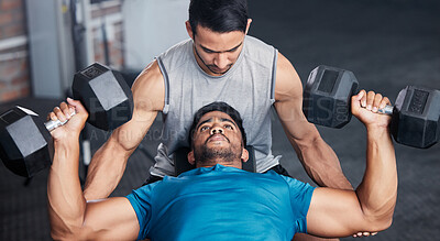 Buy stock photo Fitness, personal trainer and workout bench in gym with dumbbell for training, bodybuilding and cardio. Exercise, athlete and professional bodybuilder coach helping client with lifting technique.


