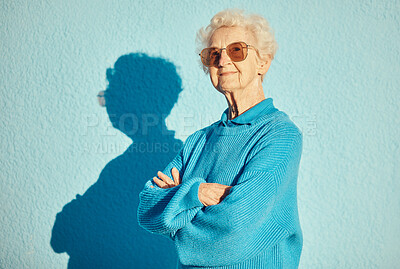 Buy stock photo Fashion, sunglasses and portrait of old woman with arms crossed on wall background for stylish, cool and unique aesthetic. Retirement, beauty and elderly female model with designer brand glasses.