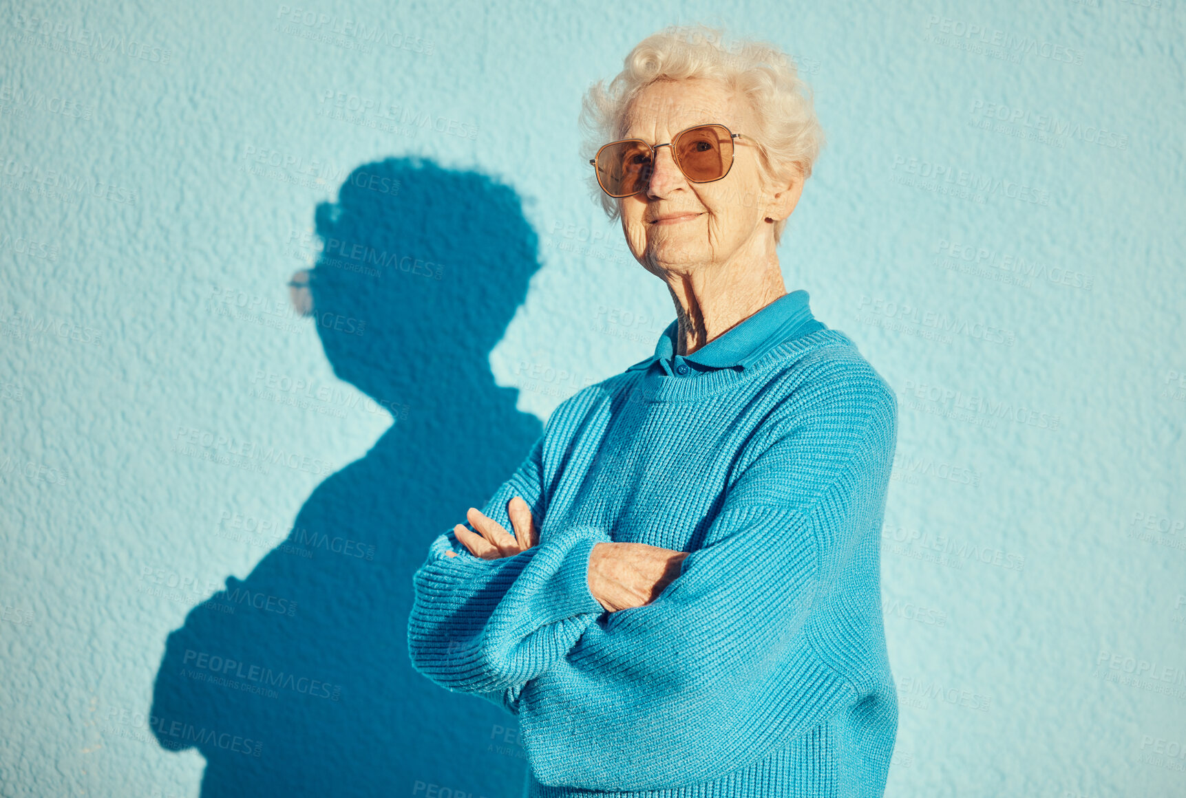 Buy stock photo Fashion, sunglasses and portrait of old woman with arms crossed on wall background for stylish, cool and unique aesthetic. Retirement, beauty and elderly female model with designer brand glasses.