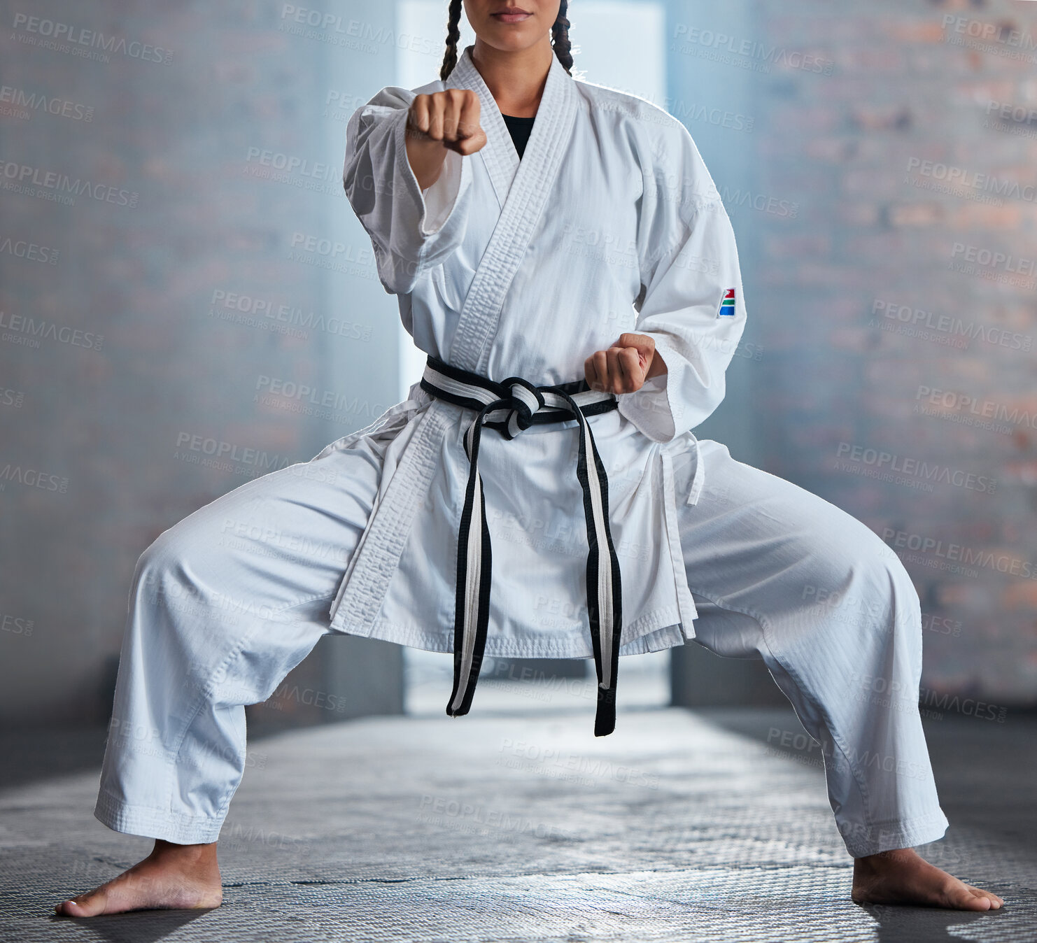 Buy stock photo Karate, sports and fitness with a woman fighter or athlete training in a gym while wearing her gi uniform. Health, sport and workout with a female martial artist exercising in a dojo or health club