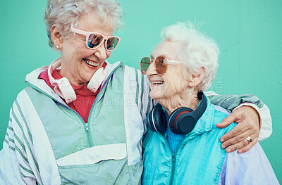 Buy stock photo Happy, fashion and elderly friends hug in cool sunglasses, vintage jackets and modern headphones outdoors. Retro, wall background and senior women hugging with pride, freedom and smile in retirement