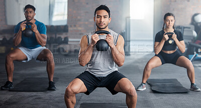 Fitness, workout and kettlebell with a personal trainer in class with a group of students for exercise. Portrait, gym and strong with a coach weight training a man and woman athlete in a sports club