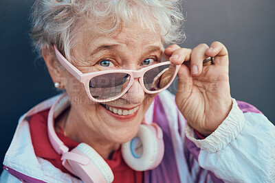 Buy stock photo Face portrait and senior woman with sunglasses, headphones and vintage clothing. Fashion, beauty and happy, retired and elderly female in retro, cool and pink designer glasses and outfit with smile.