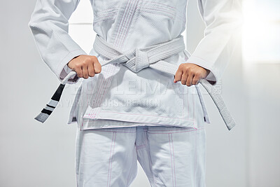 Buy stock photo karate belt, martial arts and woman ready for fight battle, white dojo training or fitness challenge workout. Warrior motivation, taekwondo and hands of girl learning self defense for safety security
