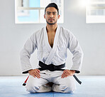 Portrait, karate and sensei with a sports man kneeling on the gym floor of a dojo or fitness club for self defense. Training, workout and fight with a martial arts professional in a sport facility