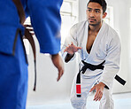 Karate, sports and sensei with man and woman fighter ready for combat sport in a gym or dojo. Fitness, workout and exercise with a male and female fight athlete training together in a health club