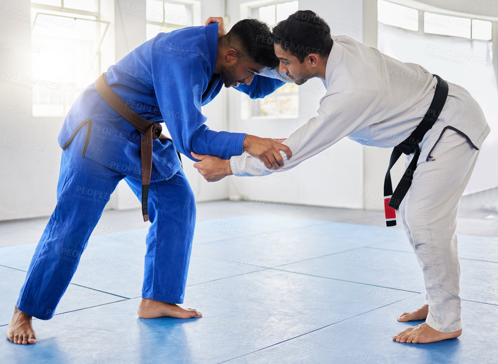 Buy stock photo Karate, martial arts and men fighting in dojo for sports and health with discipline and balance in battle. Fitness, workout  and exercise, mental wellness in fight studio or gym with warrior mindset.