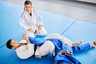 Buy stock photo Karate, personal trainer and self defense training in the dojo for physical protection or health and safety. Black belt sensei man teaching woman to defend herself in a fight or combat at the gym