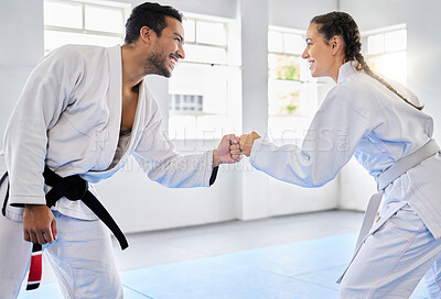 Buy stock photo Karate, motivation and fist bump with a man and woman fighter training together in a gym or dojo. Fitness, exercise and fight with a male and female athlete in a health club for combat sports