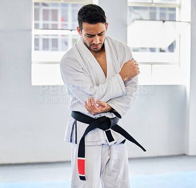 Buy stock photo Karate, arm pain and man with injury in dojo, healthcare and fighting. Sports, fitness and martial arts fighter in India with hand elbow sports injury and medical emergency in fighting gym or studio.