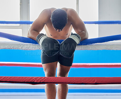 Buy stock photo Fitness, tired and sad boxer after a loss thinking about his defeat in a difficult battle in a boxing ring at a gym studio. Fatigue, loser and frustrated fighter feeling bad, depression and upset
