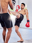 Fitness, kickboxing and mma training, exercise and fight workout in gym with men, gloves and power kick. Fight, athlete or martial arts, coaching or fighting in cardio sports or studio class together