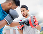 Fitness, personal trainer and boxing exercise for sports competition, training or self defense practice in the city. Boxer doing intense power workout with coach in preparation for competitive fight