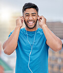 Fitness, earphones and wellness music portrait of athlete ready for outdoor triathlon training. Health, workout and happy smile of indian man getting ready for exercise with audio streaming.