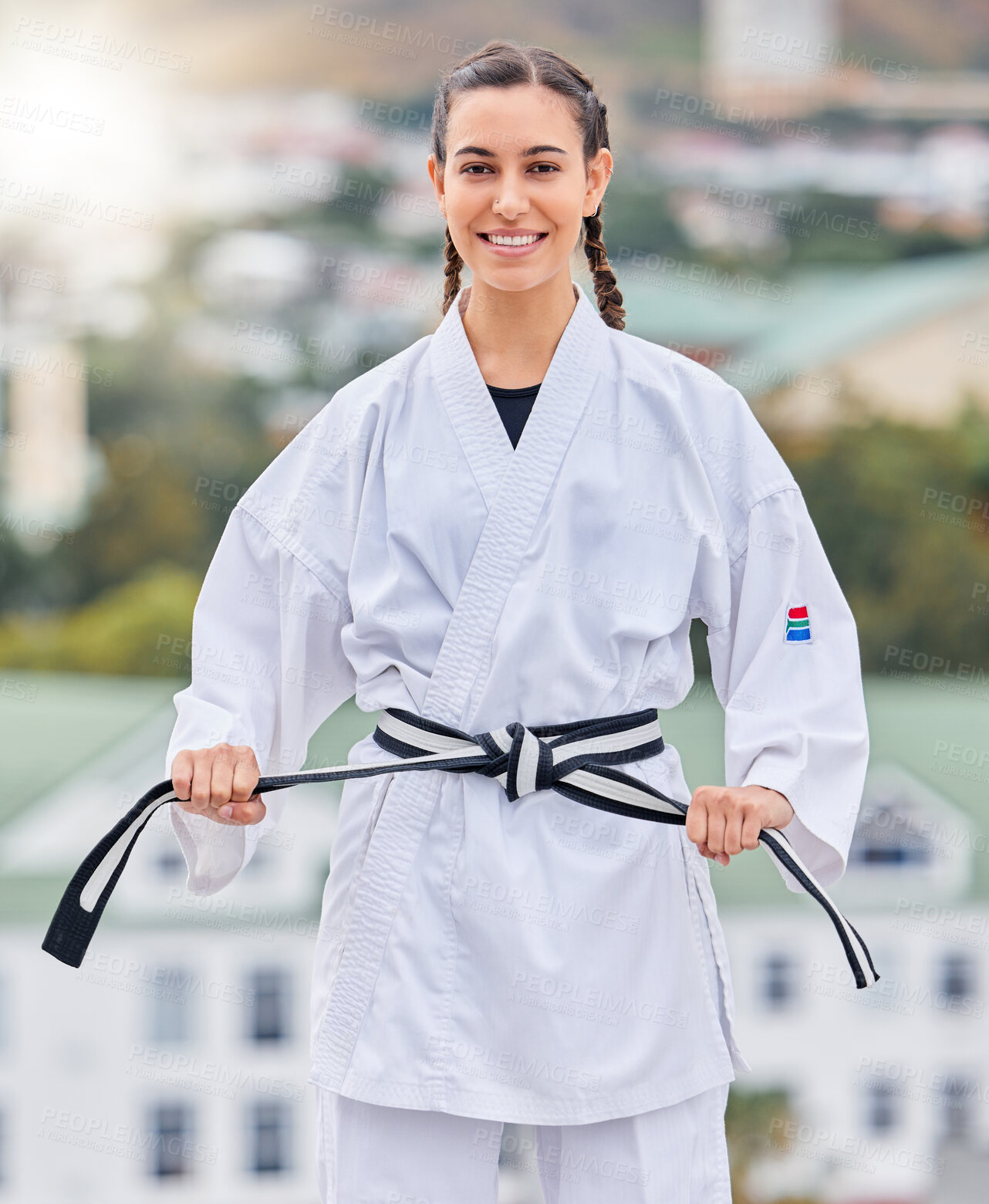 Buy stock photo Karate, ready and portrait of a woman training on a rooftop for professional event, competition and fight. Black belt, fitness and taekwondo girl with a smile for sports, body power and martial arts