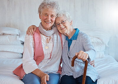 Buy stock photo Senior friends, portrait and happy smile, hug and support on a bed in a retirement house, love and care. Elderly women, happiness and connection together in nursing home bedroom in life or friendship