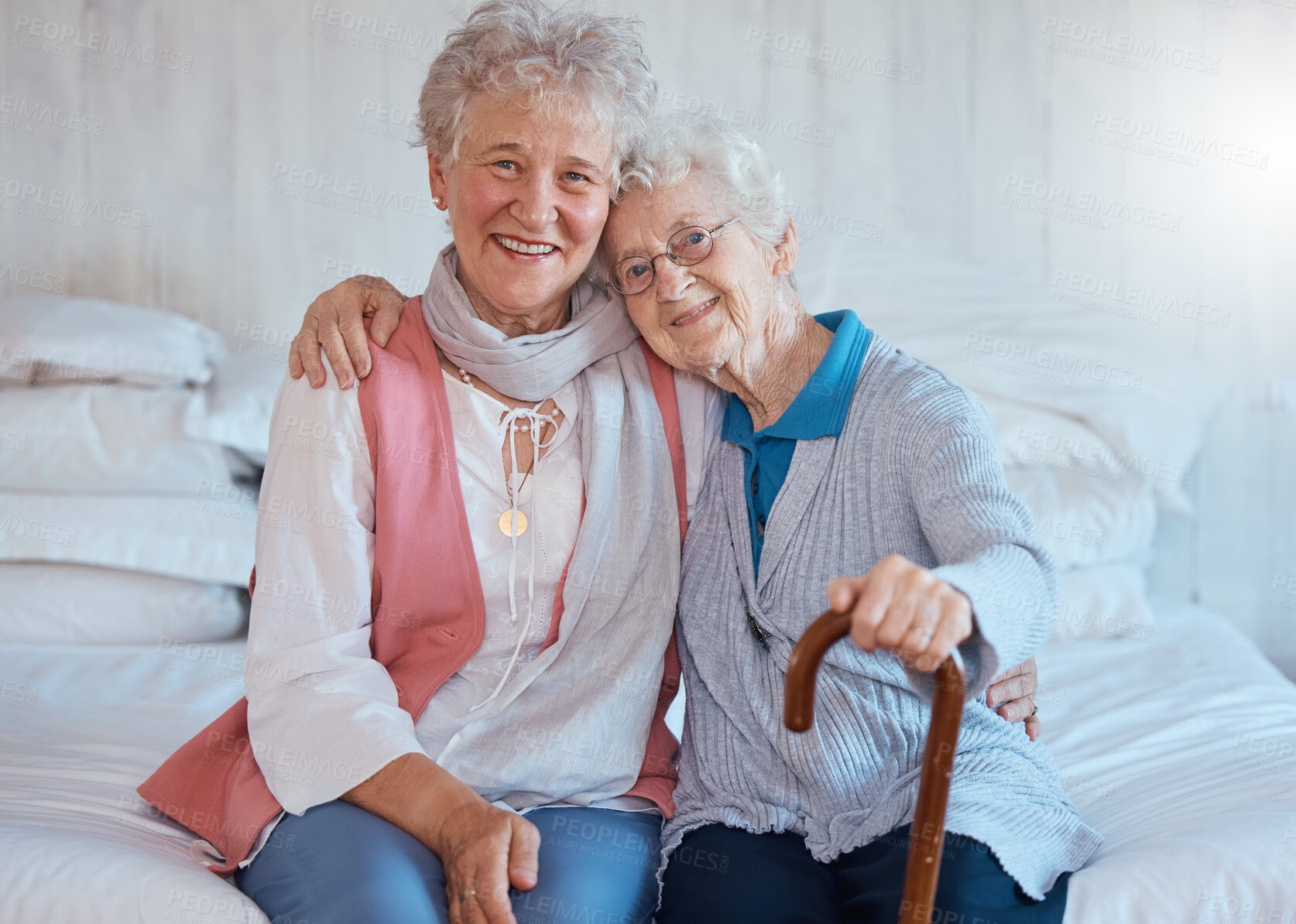 Buy stock photo Senior friends, portrait and happy smile, hug and support on a bed in a retirement house, love and care. Elderly women, happiness and connection together in nursing home bedroom in life or friendship